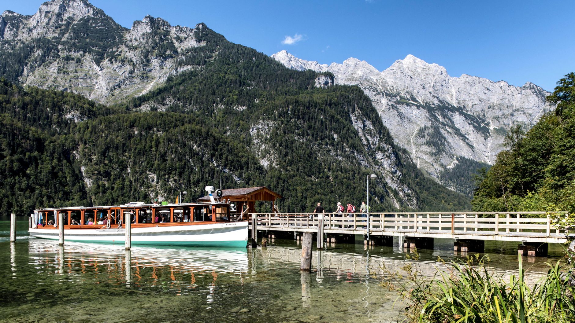 Scenic train moving along alpine lake