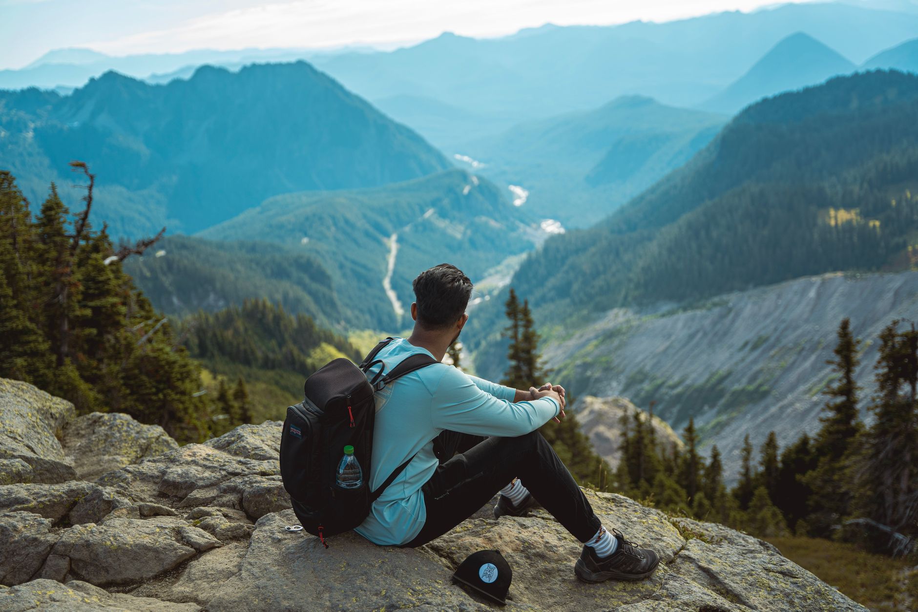 Traveler looking across mountain valley